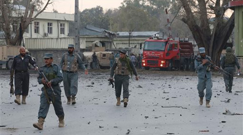 Afghan army and police gather around the area after an attack on a police station in Jalalabad. (AP)