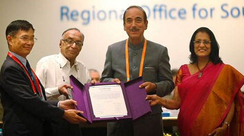 Chairperson, South-East Asia Regional Certification Commission for Polio Eradication Supamit Chunsuttiwat, left, and WHO's South-east Asian region Regional Director Poonam Khetrapal, right, give polio free certification to  Health Minister Ghulam Nabi Azad on Thursday. (AP)