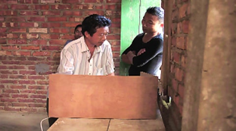 At Booth 44/2 in Senakeithei in Outer Manipur LS constituency, a voter is watched on Wednesday.