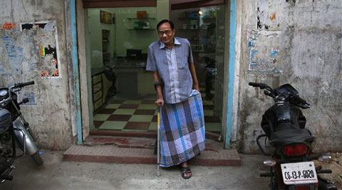 In this April 15, 2014 photo, India's Ramesh Agrawal walks outside his shop during an interview in Raigarh in Chhattisgarh state, India. (AP)