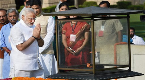 Prime Minister-designate Narendra Modi pays his respects at Rajghat, the memorial of Mahatma GandhI. (Source: AP photo)