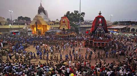 Devotees and paramilitary forces pull chariots to set in front of the Lord Jagannath temple, on the eve of the annual Rath Yatra, (Source: AP Photo)