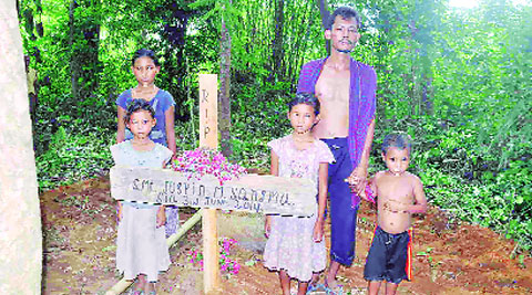 Jospin’s husband and her four children at her burial site at Duragre  village in Meghalaya Thursday. DASARATH DEKA