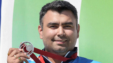 Gagan Narang flaunts his medal at the podium in Glasgow. (Source: PTI)