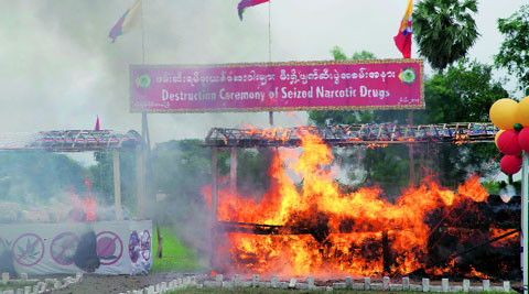In Myanmar, source of the narcotic, a seized consignment of methamphetamine is set on fire. ( Source: AP )