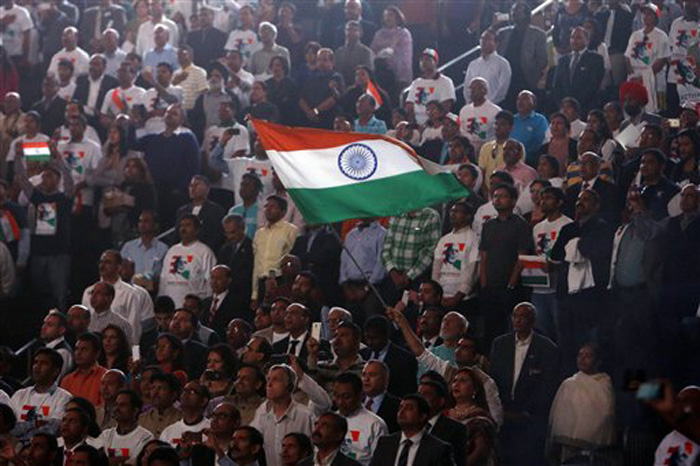Supporters wave an Indian flag as Prime Minister Narendra Modi prepares to address during a reception organised in his honour by the Indian American Community Foundation at Madison Square Garden in New York on Sunday. (Source: PTI)