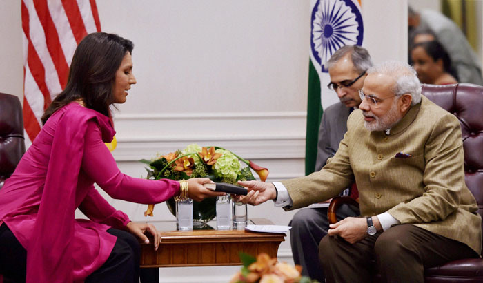  Influential lawmaker Tulsi Gabbard, the only Hindu member of the US Congress, met Prime Minister Narendra Modi in New York and presented her personal copy of Bhagavad Gita to him, saying it was a gesture to express her love for India. (Source: PTI) 