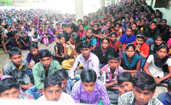 Students watch Prime Minister Narendra Modi's speech on television in Narmada, Gujarat on Teachers' day.