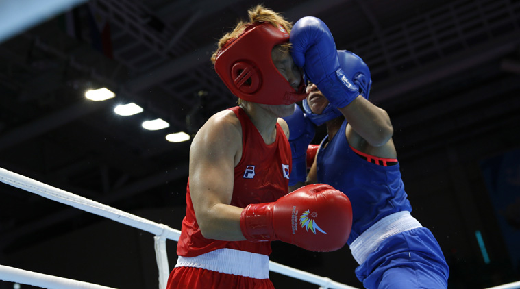 OOUCH! South Korea's Park Ji-na (red) fights with India's Laishram Sarita Devi during their women's light (57-60kg) semi-final (Source: Reuters)