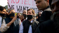 With mouth covered, Rahul finds his voice