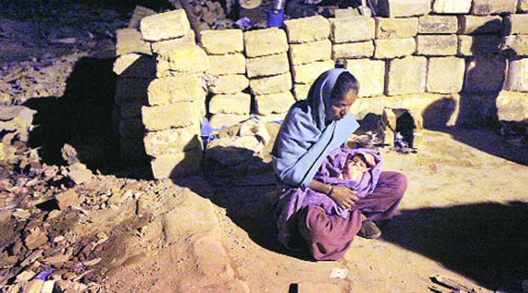 A homeless woman with her month-old baby at Rangpuri Pahadi slums.