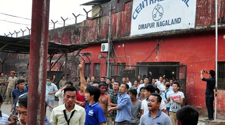 In this Thursday, March 5, 2015 photo, members of a mob pull a man, centre with blooded face, accused of rape, out of the Central Jail where he was held in Dimapur, in the northeastern Indian state of Nagaland. Several thousand people overpowered security at Dimapur Central Prison in Nagaland on Thursday, and seized the rape suspect, whom they also accused of being an illegal migrant from Bangladesh. They pelted him with stones and beat him to death, said police Constable Sunep Aier. (Source: AP)