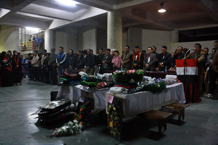 Mourners pray for the slain policemen during the ceremony of mourning organised by the YMA, a community-based organisation, soon after the convoy's arrival before dawn on Sunday.