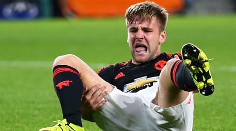 Manchester Uniteds Luke Shaw grimaces after being injured during the Champions League Group B soccer match between PSV and Manchester United at Philips stadium in Eindhoven, Netherlands, Tuesday, Sept. 15, 2015. (AP Photo/Peter Dejong)