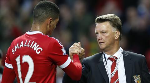 Manchester United's manager Louis van Gaal greets Chris Smalling after the English Premier League soccer match between Manchester United and Liverpool at Old Trafford Stadium, Manchester, England, Saturday, Sept. 12, 2015. United won the match 3-1. (AP Photo/Jon Super)