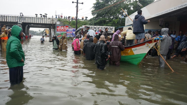 Early morning on Wednesday, public and local police deployed dozens of boats to rescue over 1,000 families stranded in flood hit areas south of Chennai city. This Pic is from Mudichur near Tambaram. (Source: Express photo by Arun Janardhanan)