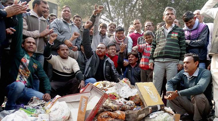 MCD workers shot slogans while piling up garbage near Deputy Chief Minister Manish Siosodia’s office during a protest over their their demands in East Delhi last year. Credit: PTI/FIles