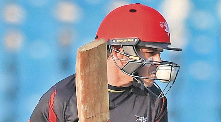 Hong Kong batsman Ryan Campbell finds his helmet crowded by something it is supposed to keep out — the ball. (Source: PTI)