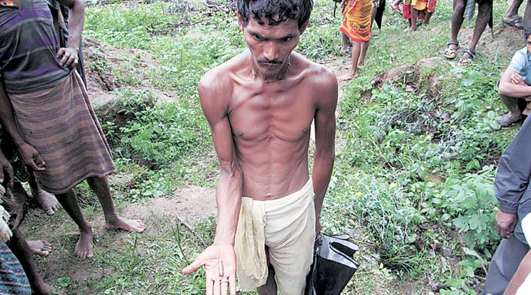 Mallick shows a cartridge he found where his wife was killed. (Source: Express photo by Debabrata Mohanty)