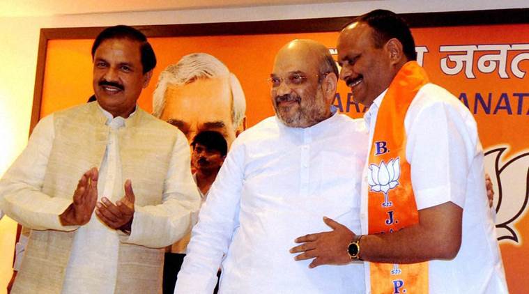 Brajesh Pathak with BJP President Amit Shah and Tourism Minister Mahesh Sharma after joining BJP in New Delhi on Monday. Pathak quit BSP to join BJP. PTI Photo  