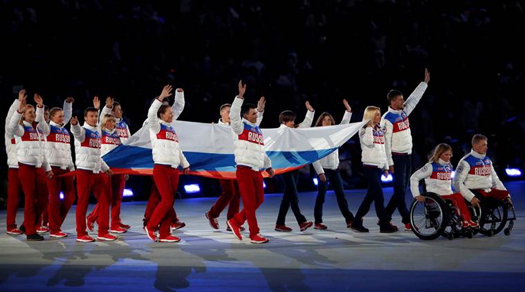 Performers carry Russian national flag during closing ceremony of 2014 Paralympic Winter Games in Sochi
