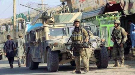 Afghan forces battle to retake district from Taliban