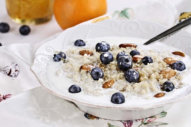 Cooked Quinoa with blueberries, almonds and honey. Selective focus with extreme shallow depth of field.