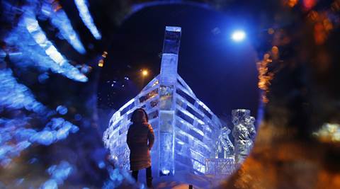 A woman looks at the boat ice sculpture at the launch of Hyde Park Winter Wonderland's Magical Ice Kingdom in London, Thursday, Nov. 17, 2016. This years Winter Wonderland starts on November 18, 2016 and lasts until January 2, 2017. (AP Photo/Frank Augstein)