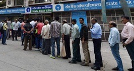 New Delhi: People queue up at out side of banks ATM to get money in New Delhi on Sunday. PTI photo by Vijay Verma(PTI11_13_2016_000071A)