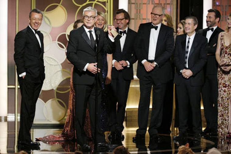 This image released by NBC shows Peter Morgan, from left, Stephen Daldry and the cast and crew of "The Crown," winner of the best drama TV series at the 74th Annual Golden Globe Awards at the Beverly Hilton Hotel in Beverly Hills, Calif., on Sunday, Jan. 8, 2017. (Paul Drinkwater/NBC via AP)