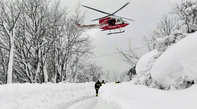 An Italian firefighters helicopter flies during rescue operations in the area where an hotel was hit by an avalanche in Farindola, Italy, early Thursday, Jan. 19, 2017. A hotel in the mountainous region hit again by quakes has been covered by an avalanche, with reports of dead. Italian media say the avalanche covered the three-story hotel in the central region of Abruzzo, on Wednesday evening. (Matteo Guidelli/ANSA via AP)