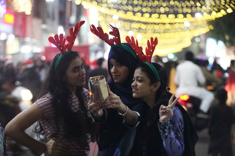 Young girls taking selfies in Pune’s MG Road. (Express photo by Pavan Khengre)