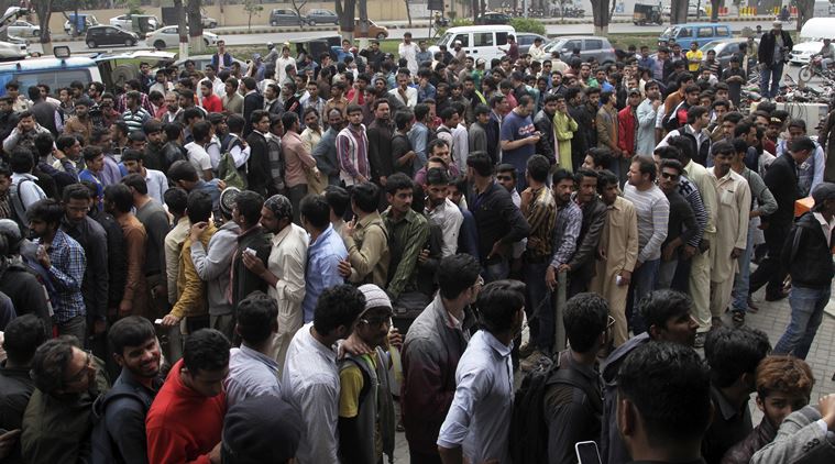 Cricket lovers gather outside a bank to buy ticket for upcoming final cricket match of Pakistan Super League, in Lahore, Pakistan. (Source: AP)