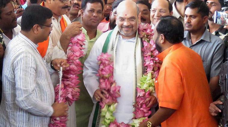 Image result for Modi greeted Amit Shah for winning in Rajya Sabha Elections