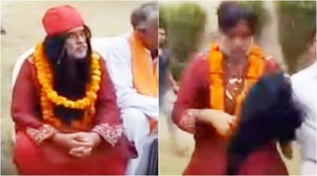 WATCH: Swami Om gets beaten up so badly at Delhi event that his wig comes off