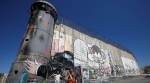 Bethlehem graffiti lampoons Trump embrace of Israeli wall