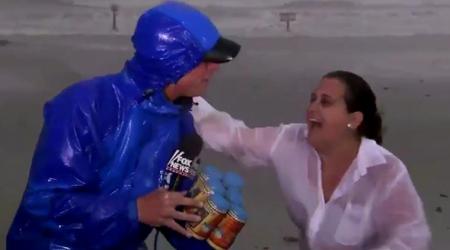 Video: Woman hands over BEER CANS to reporter covering Hurricane Harvey on LIVE TV