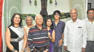 Three Pune youths unveil tree made from 100 glass bottles