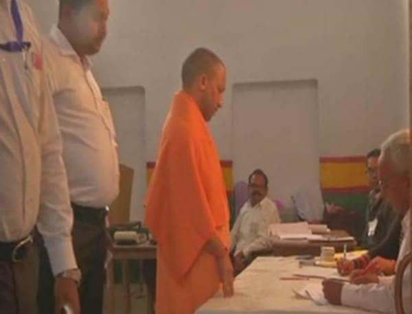 Uttar Pradesh Chief Minister Yogi Adityanath arrives at a polling station in Gorakhpur to cast his vote.