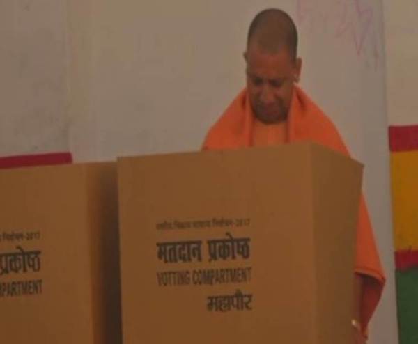 Uttar Pradesh Chief Minister Yogi Adityanath arrives at a polling station in Gorakhpur to cast his vote.