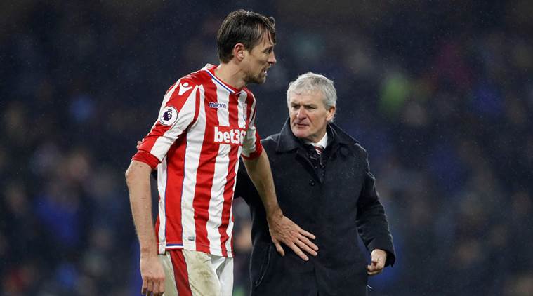 Stoke City's Peter Crouch with manager Mark Hughes 