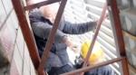 WATCH: Old man gets stuck on ad board after falling from balcony; firefighters come to the rescue