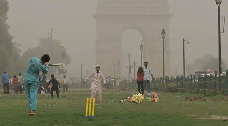 New Delhi: Children play cricket as the weather changes after a dust storm in New Delhi on Wednesday. (PTI)
