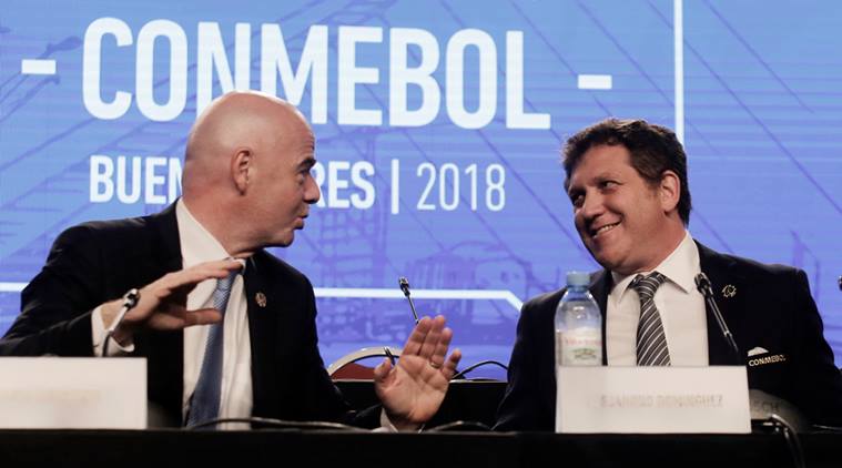 FIFA President Gianni Infantino, left, talks with Alejandro Dominguez, right, president of the South American Football Confederation