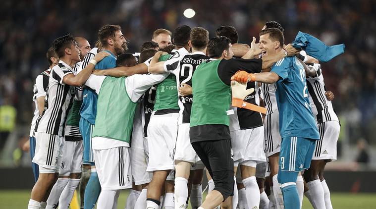 Juventus players celebrate at the end of the Serie A soccer match between Roma and Juventus, at the Rome Olympic stadium