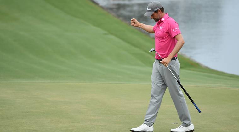 Webb Simpson celebrates on the 18th green after winning the final round of The Players Championship golf tournament
