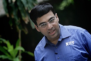 V. P. Kaushik, 11, watches as Indian World Rapid Chess Champion Viswanathan  Anand, unseen right, makes a move at the launch of a school chess  tournament organized by the NIIT Mind Champion's