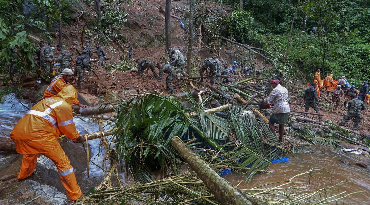Rescuers search for bodies of victims amist the debris of a landslide following heavy rains atKoottickal in Kottayam district, southern Kerala state, India, Sunday, Oct.17, 2021. More than two dozen people have died in the state due to intense rains which have triggered floods and landslides. (AP Photo)