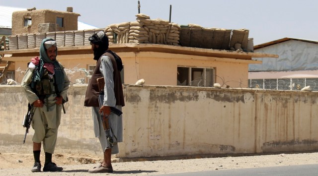 Taliban fighters stand guard inside the city of Ghazni, southwest of Kabul, Afghanistan, Friday, Aug. 13, 2021.  The Taliban have completed their sweep of the countryÄôs south on Friday, as they took four more provincial capitals in a lightning offensive that is gradually encircling Kabul, just weeks before the U.S. is set to officially end its two-decade war.   (AP Photo/Gulabuddin Amiri)