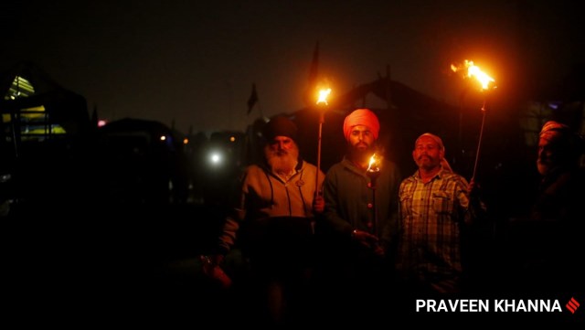 Farmers protest at Singhu border in New Delhi on Friday. (Express Photo by Praveen Khanna)